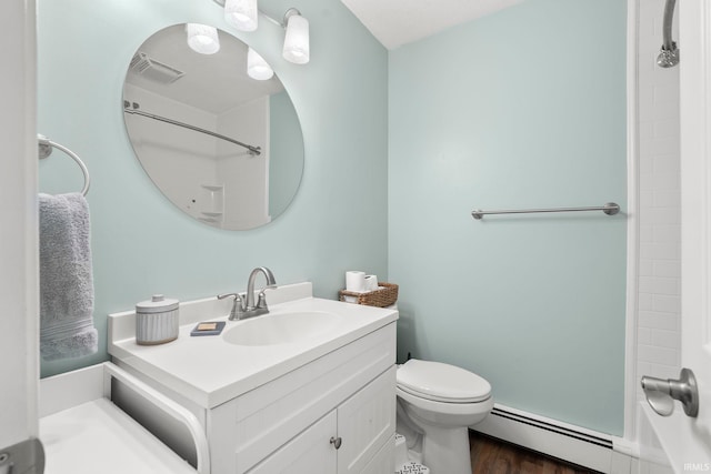 bathroom featuring a baseboard radiator, visible vents, toilet, vanity, and wood finished floors