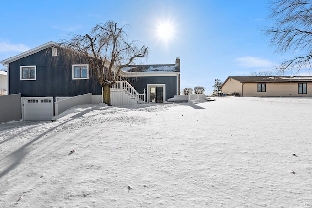 snow covered property featuring a garage