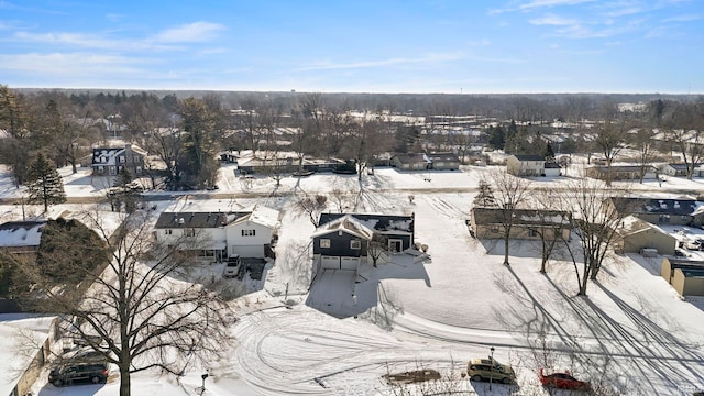 snowy aerial view featuring a residential view