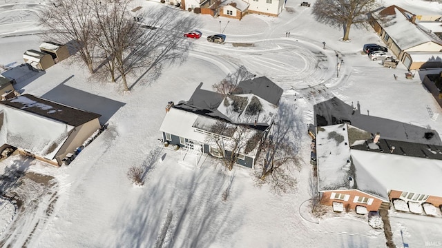 snowy aerial view with a residential view