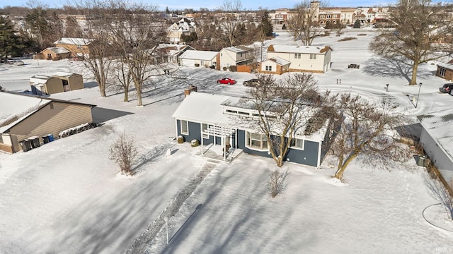 snowy aerial view with a residential view