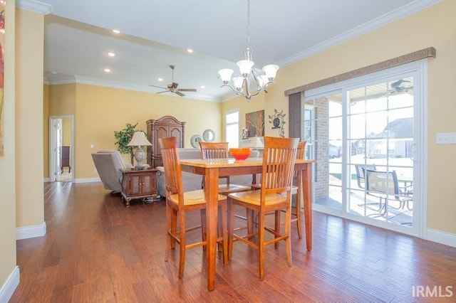 dining room with dark wood-style floors, ornamental molding, and baseboards