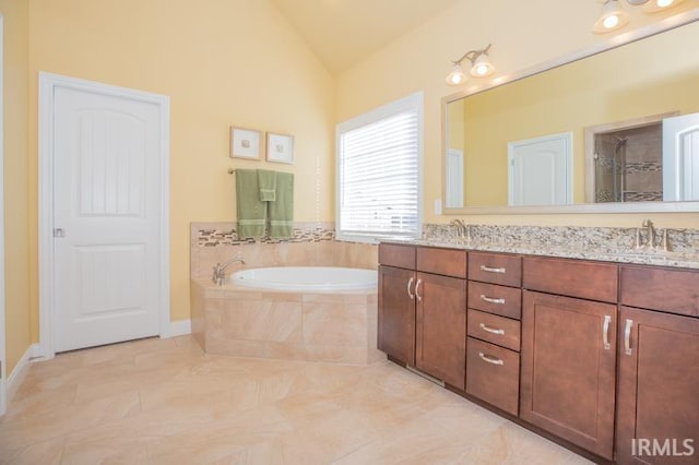 bathroom with a garden tub, a shower with shower door, a sink, vaulted ceiling, and double vanity