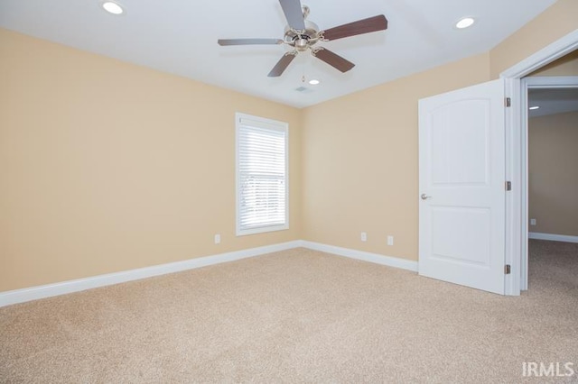 carpeted spare room featuring ceiling fan, recessed lighting, and baseboards