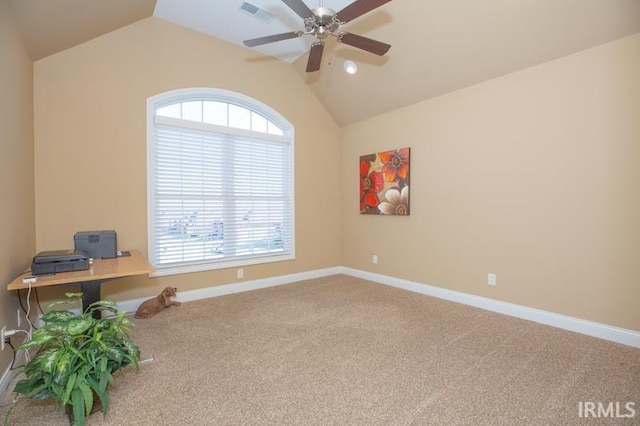 carpeted office space with lofted ceiling, baseboards, visible vents, and a ceiling fan