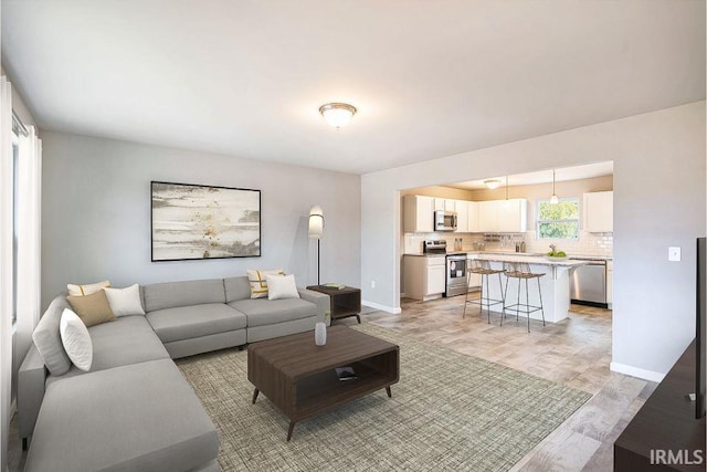 living area featuring baseboards