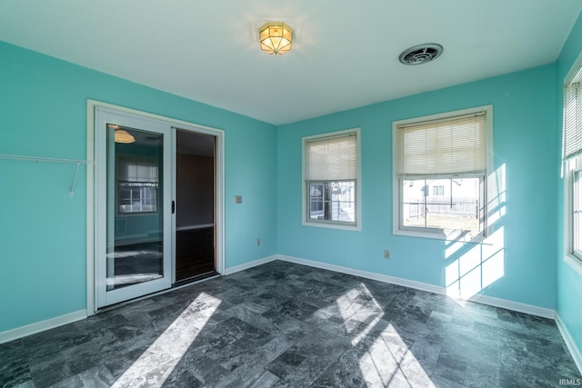 empty room with visible vents and baseboards