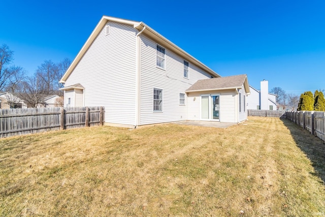 back of property featuring a fenced backyard, a lawn, and a patio