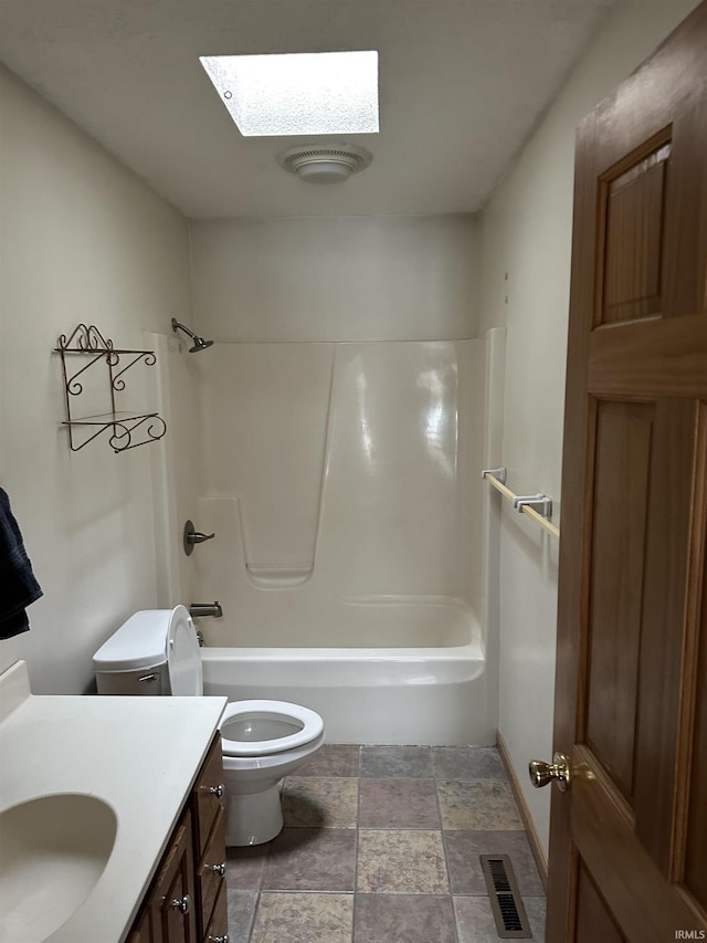 full bathroom with a skylight, visible vents, toilet, vanity, and  shower combination