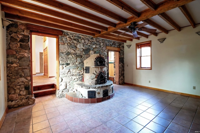 unfurnished living room featuring ceiling fan, baseboards, beam ceiling, and light tile patterned flooring