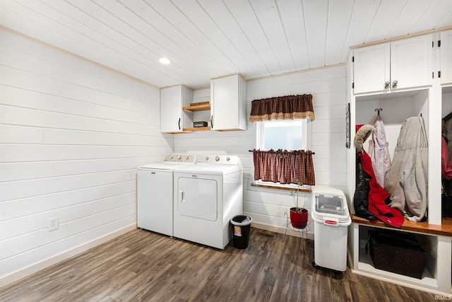 clothes washing area featuring wooden ceiling, cabinet space, washer and clothes dryer, and dark wood-style flooring