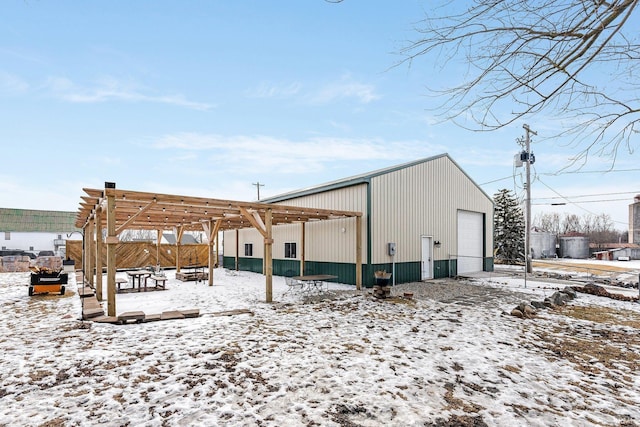 snow covered structure featuring an outdoor structure