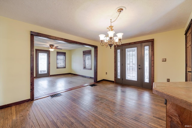 entryway featuring a chandelier, visible vents, dark wood finished floors, and a textured ceiling