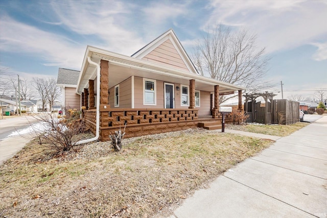 view of front of house featuring a porch and fence