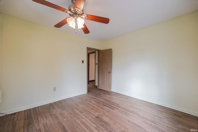 unfurnished room with a ceiling fan, light wood-style flooring, and baseboards