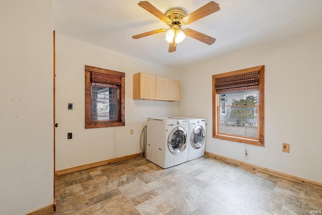 washroom featuring ceiling fan, washing machine and clothes dryer, cabinet space, and baseboards