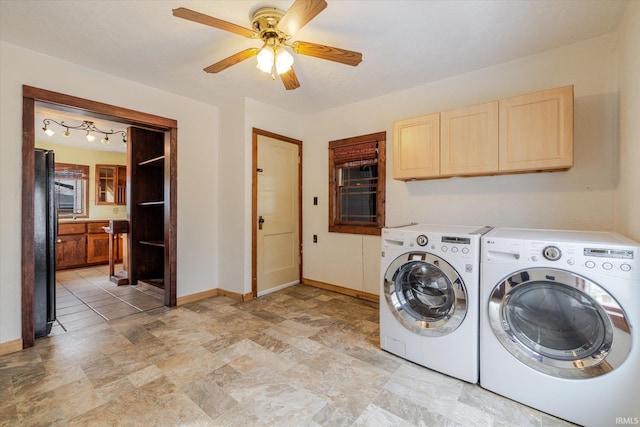 laundry room featuring cabinet space, ceiling fan, washer and clothes dryer, and baseboards