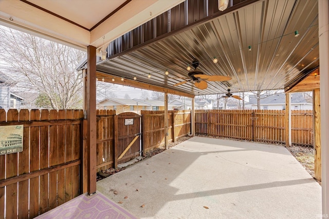 view of patio with fence private yard, a gate, and ceiling fan