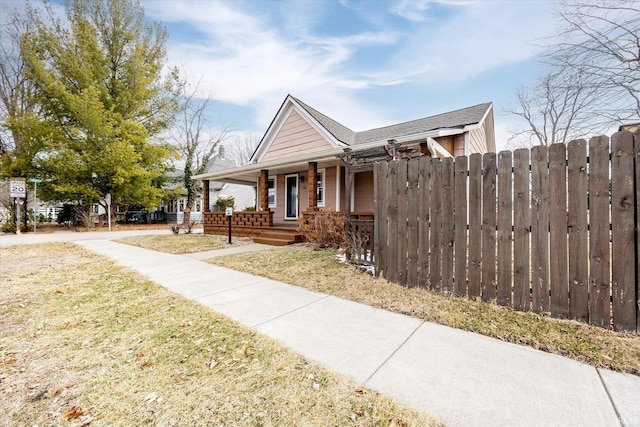 exterior space featuring a yard, covered porch, and fence