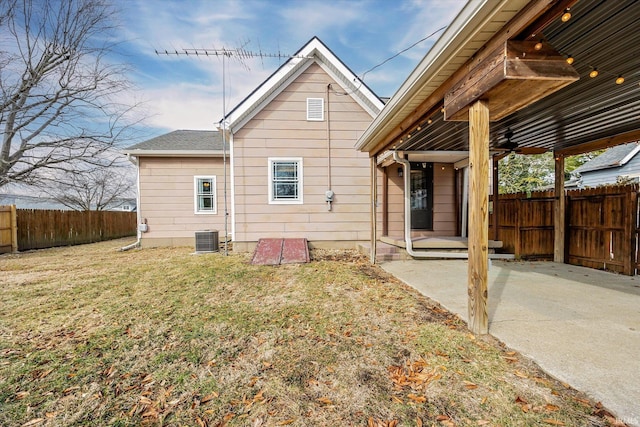 rear view of property featuring a yard, a patio, ceiling fan, fence, and cooling unit