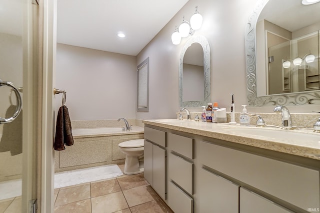 bathroom with double vanity, a garden tub, a sink, and tile patterned floors