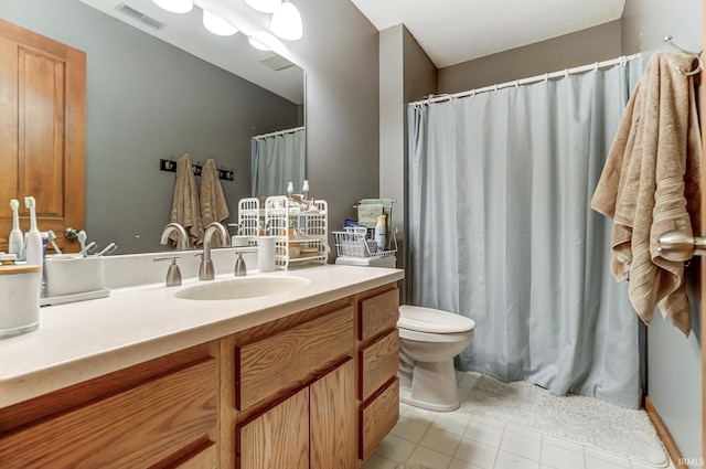 full bathroom with toilet, vanity, visible vents, and tile patterned floors