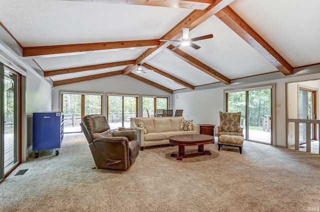 living room featuring a wealth of natural light, carpet, visible vents, and lofted ceiling with beams