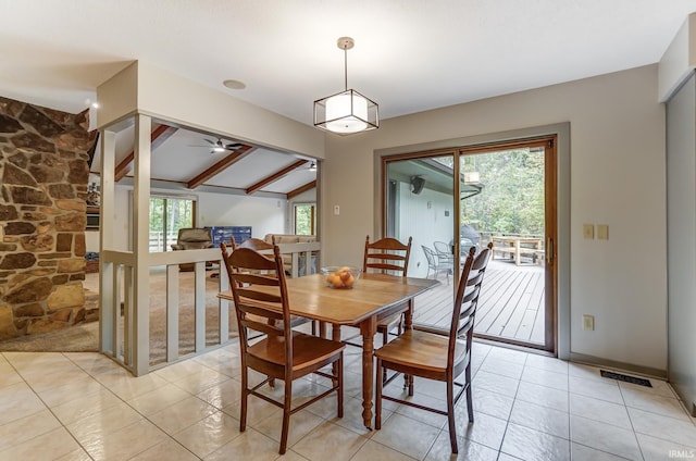 dining room featuring visible vents, light tile patterned floors, a wealth of natural light, and vaulted ceiling with beams