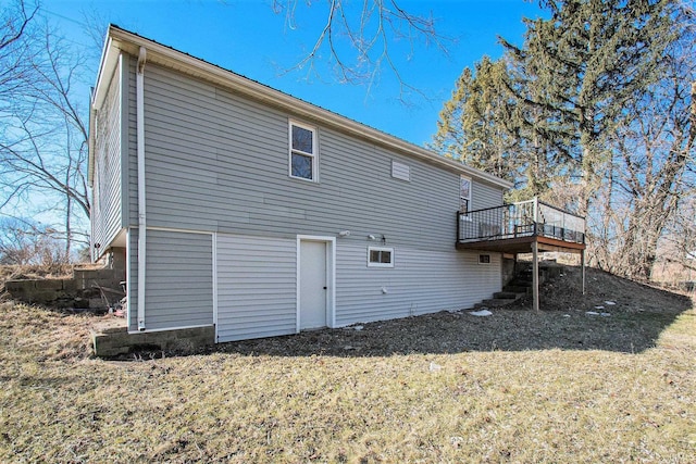 rear view of property with a yard and a wooden deck