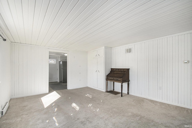 unfurnished room featuring visible vents and baseboard heating