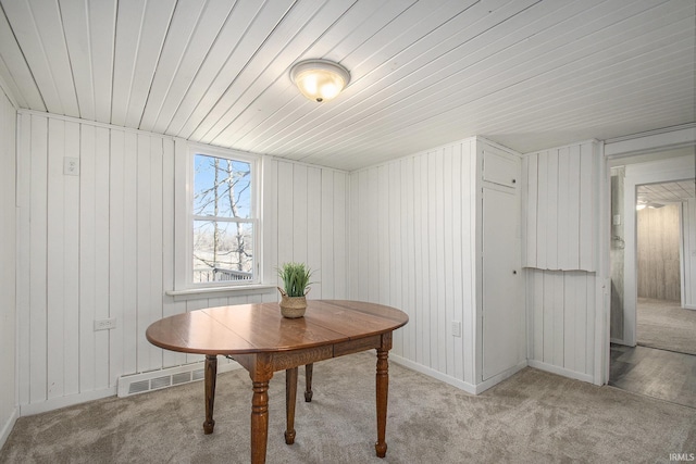 dining space with light carpet, visible vents, and baseboards