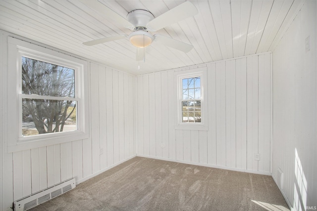 unfurnished room featuring ceiling fan, a baseboard radiator, and carpet flooring