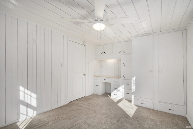 unfurnished bedroom with ceiling fan and light colored carpet