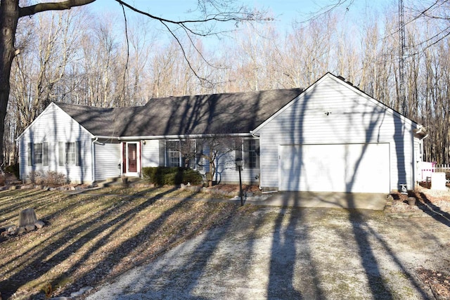 ranch-style home featuring entry steps, driveway, and an attached garage