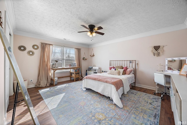 bedroom featuring dark wood-style floors, crown molding, baseboards, and a ceiling fan