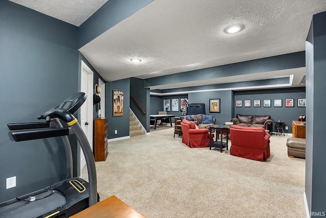 interior space featuring a textured ceiling, carpet flooring, and baseboards