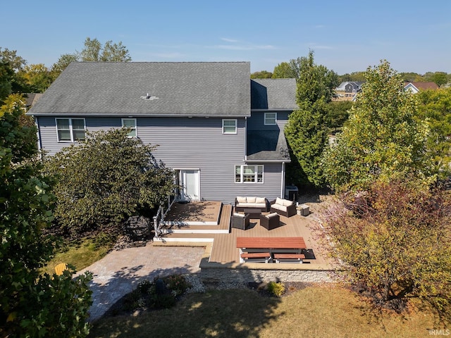 back of property featuring an outdoor hangout area, a deck, and a shingled roof