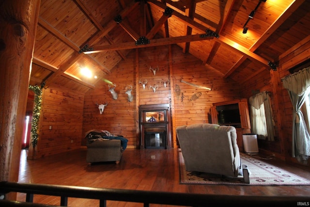 living room featuring a fireplace, wood-type flooring, lofted ceiling with beams, wood ceiling, and track lighting