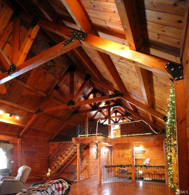 unfurnished bedroom with lofted ceiling with beams, wood walls, and wood ceiling