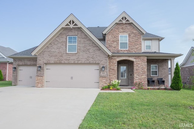 craftsman inspired home featuring brick siding, covered porch, a front yard, a garage, and driveway