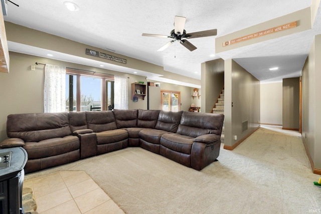 living area featuring recessed lighting, light colored carpet, stairway, a textured ceiling, and baseboards