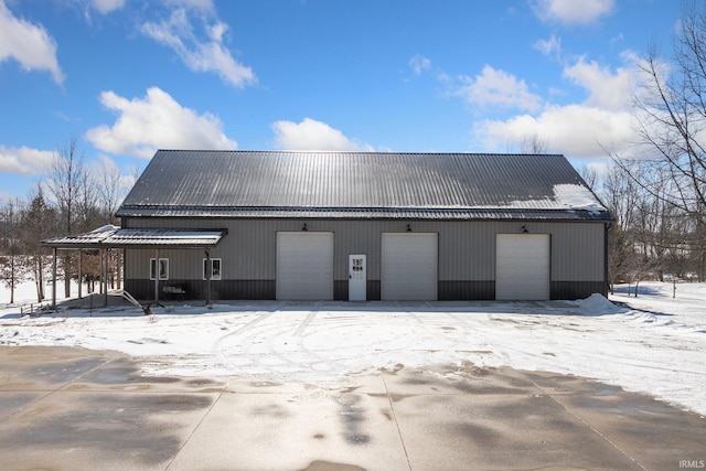 snow covered garage with a garage