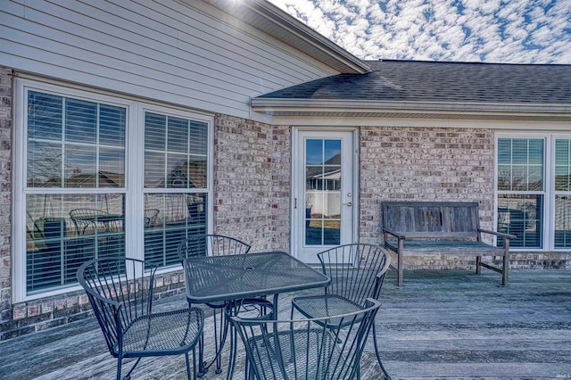 wooden deck featuring outdoor dining area