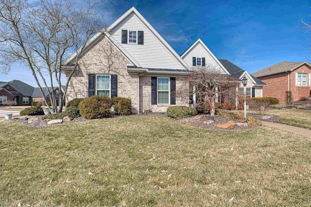 view of front of home with brick siding and a front yard