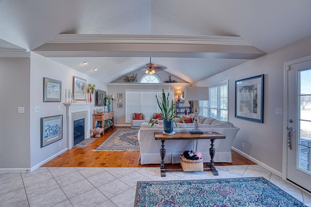 living area featuring vaulted ceiling, light tile patterned flooring, a fireplace with flush hearth, and baseboards