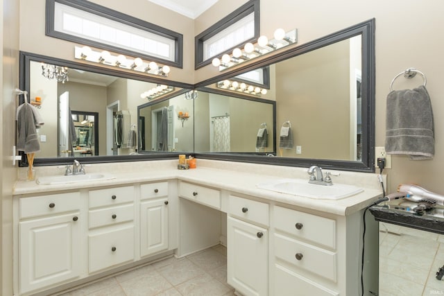 bathroom featuring double vanity, tile patterned flooring, crown molding, and a sink