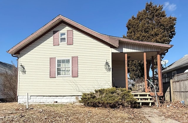 view of front facade with crawl space and fence