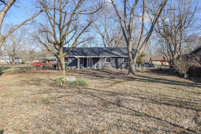 back of house with fence and a yard