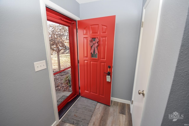 foyer entrance featuring light wood-style floors and baseboards