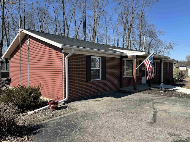 view of property exterior with brick siding